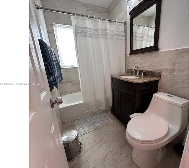 full bathroom featuring tile walls, shower / bath combination with curtain, toilet, and vanity