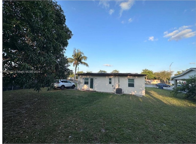 back of property featuring a lawn