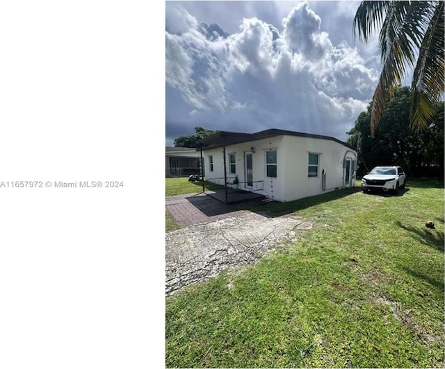 view of side of home with a lawn