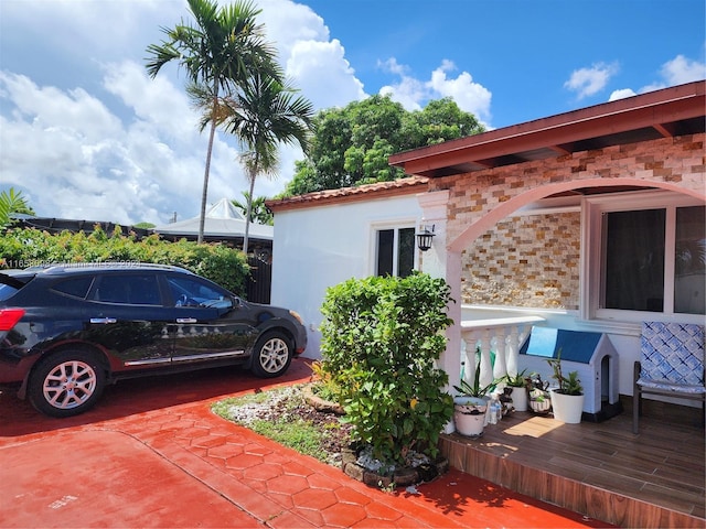 view of side of home featuring a wooden deck