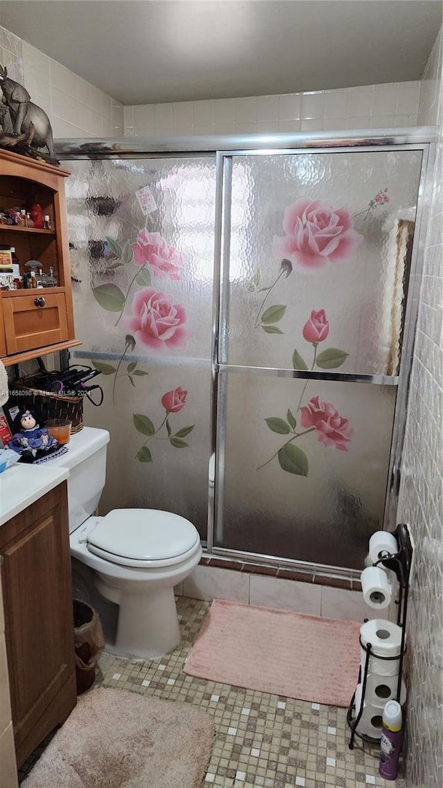 bathroom with vanity, toilet, walk in shower, and tile patterned flooring