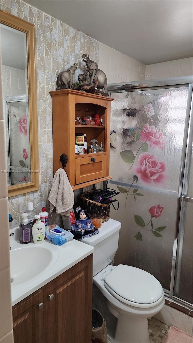 bathroom with an enclosed shower, toilet, and vanity