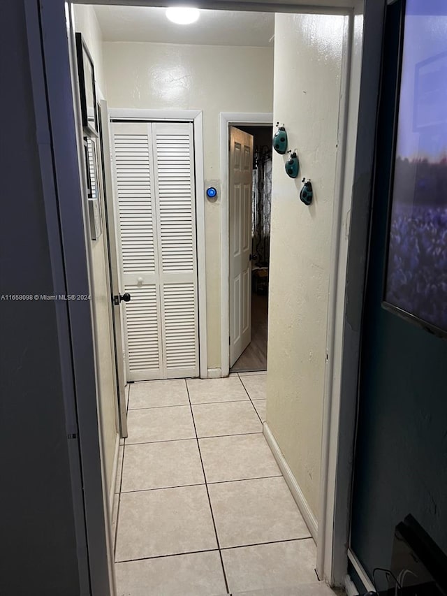 hall with light tile patterned flooring