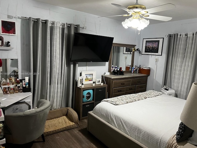 bedroom with ceiling fan and dark hardwood / wood-style flooring