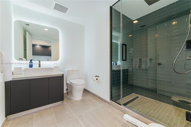 bathroom with walk in shower, vanity, toilet, and tile patterned flooring