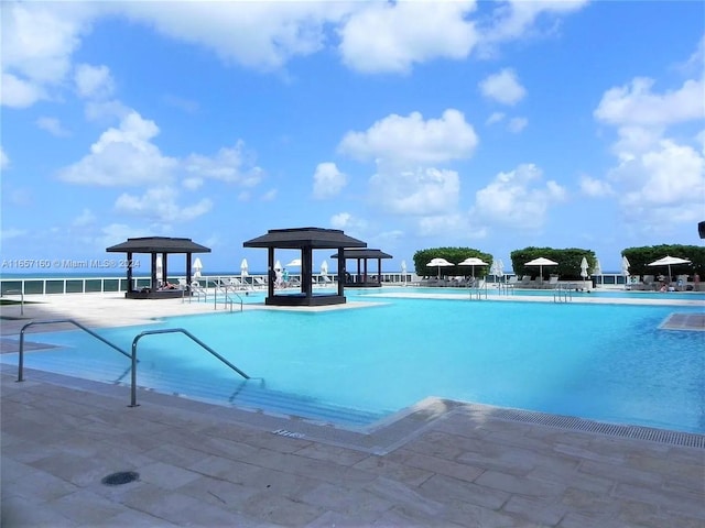 view of swimming pool with a patio and a gazebo