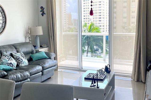 living room with a view of city, expansive windows, and light tile patterned floors