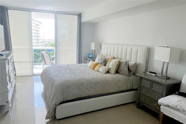 bedroom with access to exterior, expansive windows, and light tile patterned floors