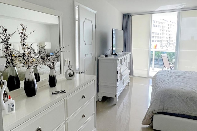 bedroom with light tile patterned floors and expansive windows