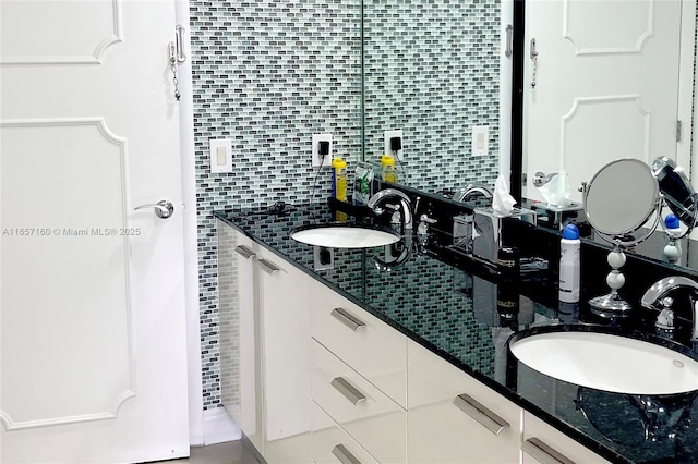 full bath featuring double vanity, tasteful backsplash, and a sink