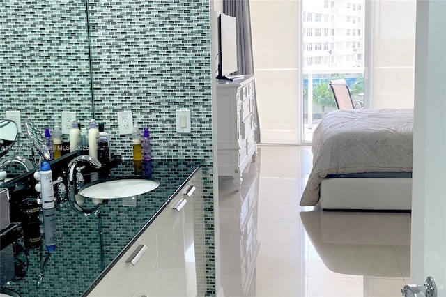 interior space with tile patterned flooring, backsplash, and vanity