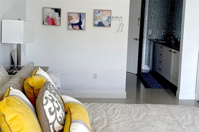 tiled bedroom featuring baseboards