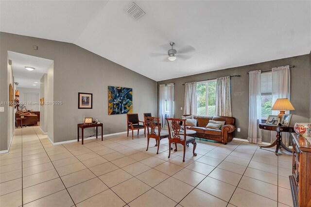 living room featuring vaulted ceiling, ceiling fan, and light tile patterned flooring