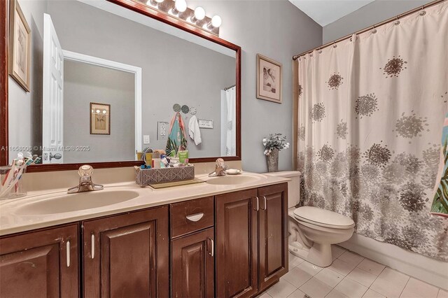 full bathroom with tile patterned floors, vanity, toilet, and shower / tub combo