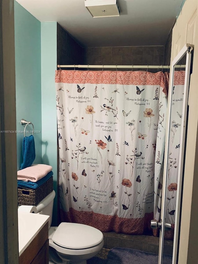 bathroom featuring tile patterned flooring, toilet, and vanity