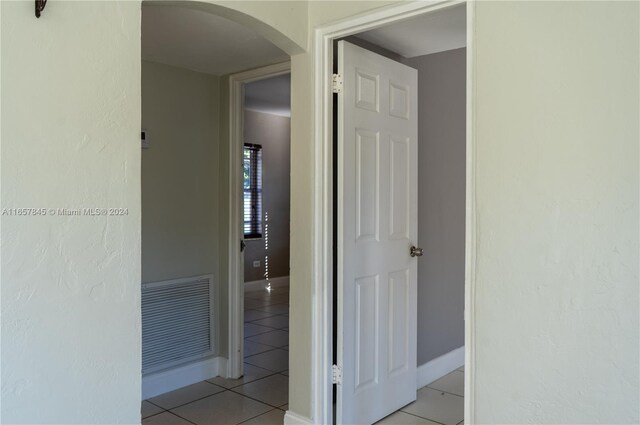 corridor with light tile patterned floors