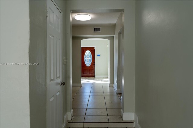 corridor featuring light tile patterned flooring