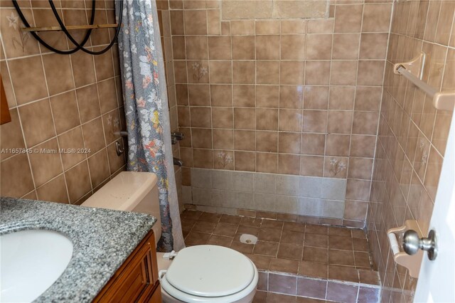 bathroom with tile patterned flooring, a shower with curtain, vanity, and toilet