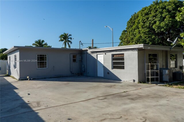 back of property with a patio area and cooling unit