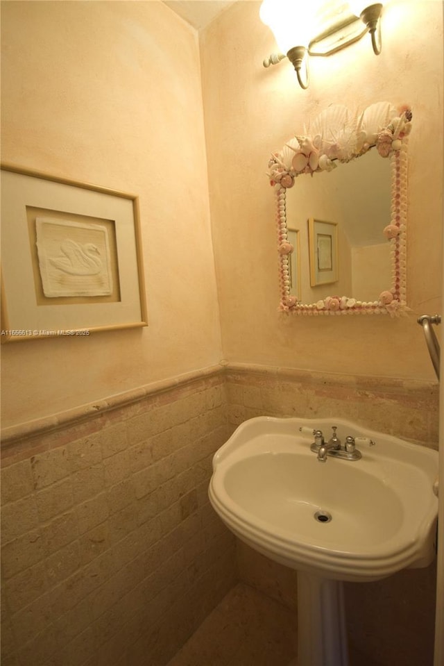 bathroom with tile walls