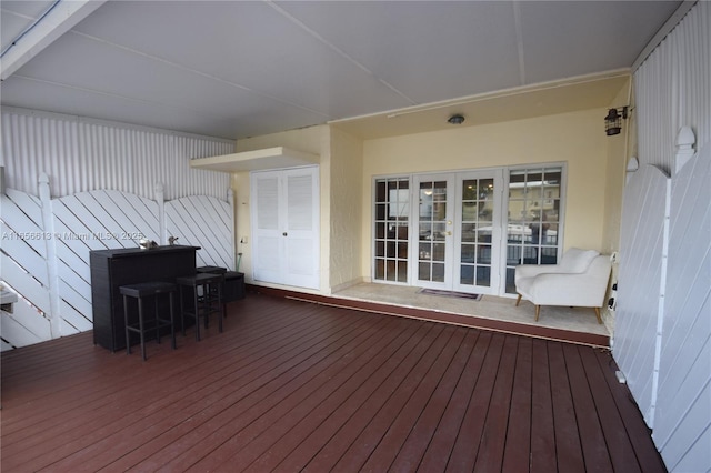 wooden deck featuring french doors and exterior bar