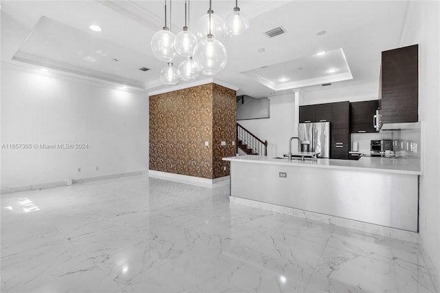 kitchen featuring a raised ceiling, sink, crown molding, hanging light fixtures, and stainless steel fridge with ice dispenser