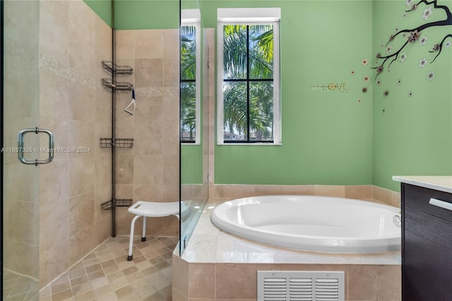 bathroom with separate shower and tub, tile patterned floors, and vanity