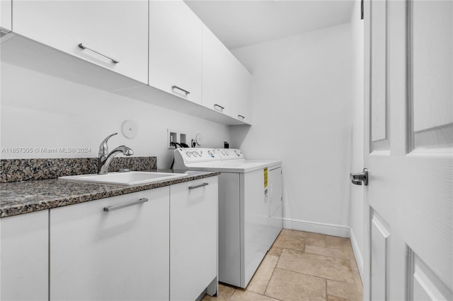 clothes washing area featuring cabinets, separate washer and dryer, and sink