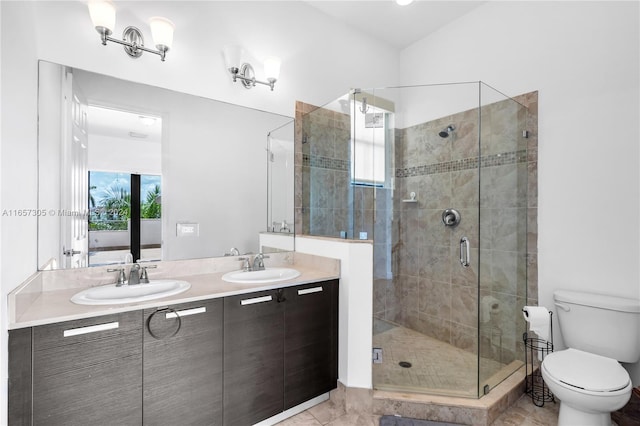 bathroom featuring vanity, toilet, and an enclosed shower