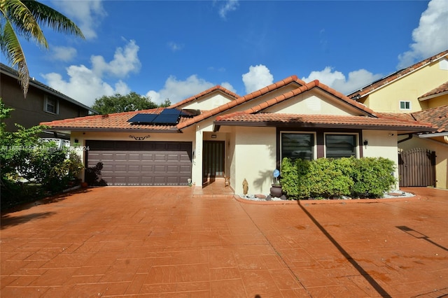 mediterranean / spanish-style house with a garage