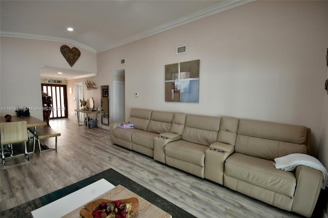 living room with ornamental molding, recessed lighting, visible vents, and wood finished floors