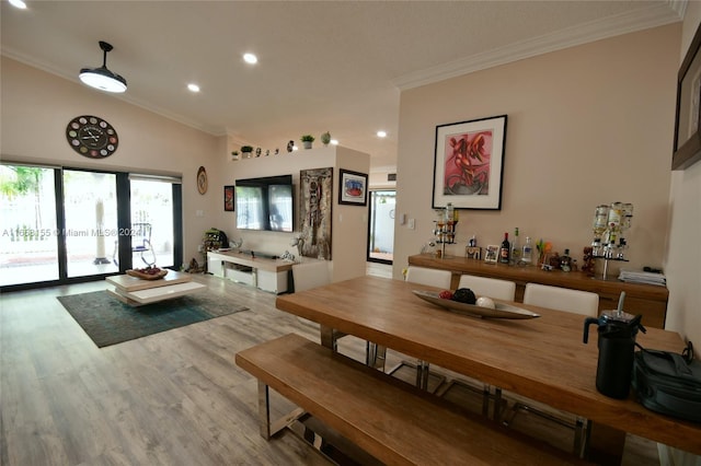 dining room featuring ornamental molding, recessed lighting, and wood finished floors