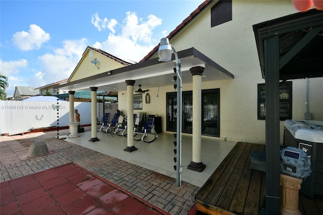 back of house featuring fence, a patio, and stucco siding