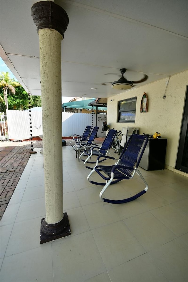 view of patio / terrace featuring fence and ceiling fan
