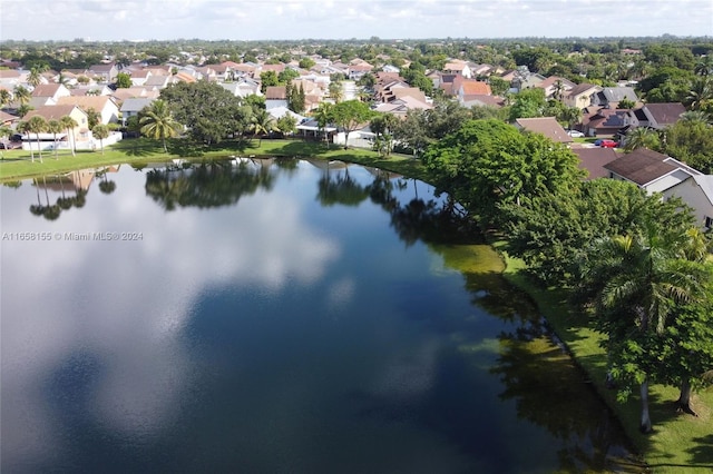 birds eye view of property with a water view and a residential view
