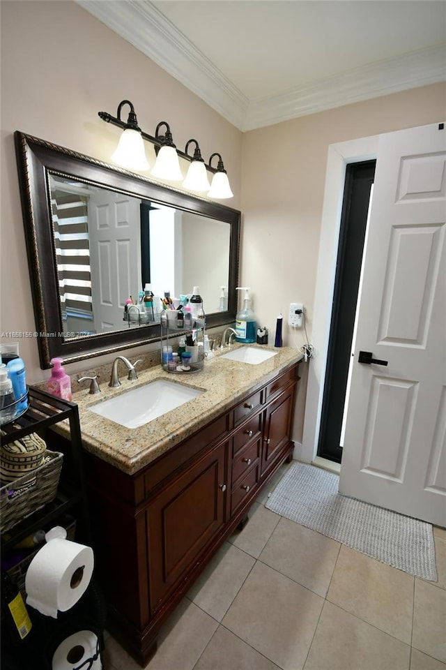 bathroom with a sink, crown molding, double vanity, and tile patterned floors