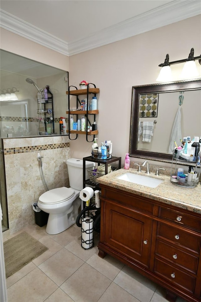 bathroom with toilet, vanity, ornamental molding, tile patterned flooring, and a tile shower