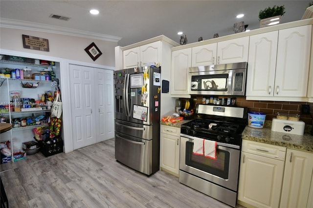 kitchen with ornamental molding, visible vents, dark stone countertops, decorative backsplash, and stainless steel appliances