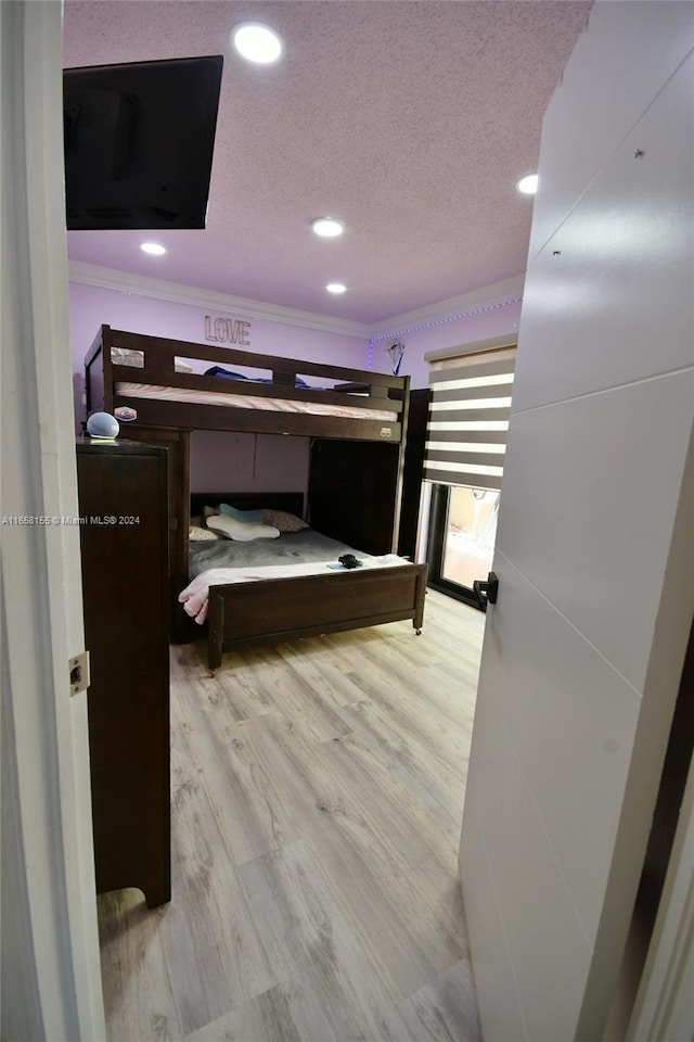 bedroom featuring crown molding, a textured ceiling, and recessed lighting