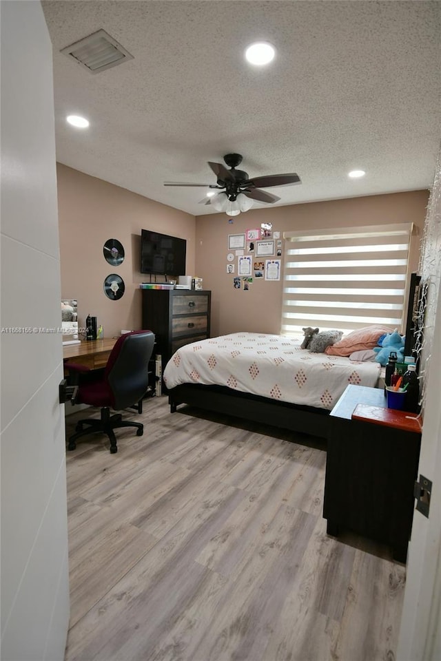 bedroom featuring recessed lighting, visible vents, a textured ceiling, and wood finished floors