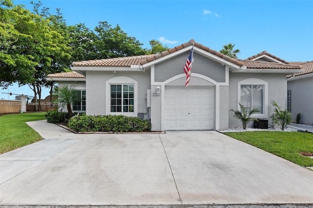 mediterranean / spanish-style house featuring a front lawn and a garage