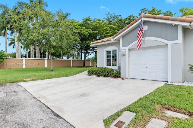 exterior space featuring a lawn and a garage