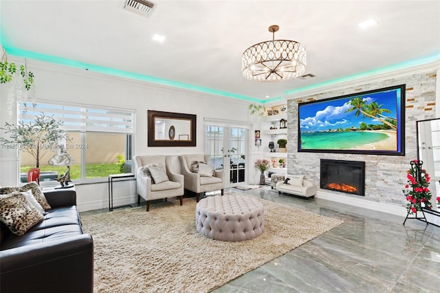 living room featuring a stone fireplace and crown molding