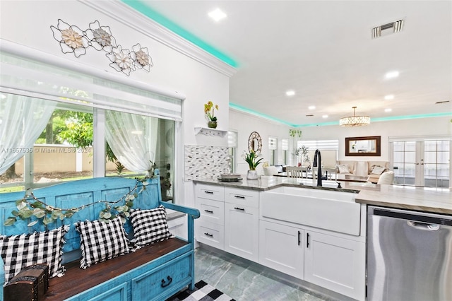 kitchen featuring a wealth of natural light, sink, dishwasher, and backsplash