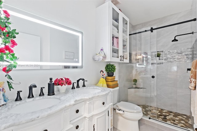 bathroom featuring vanity, a shower with shower door, toilet, and tile patterned flooring