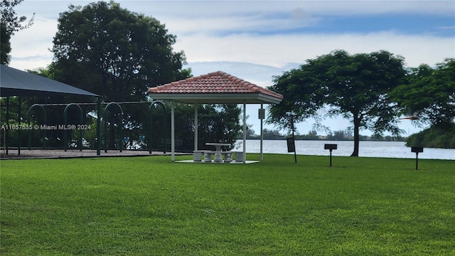 view of home's community featuring a water view, a gazebo, and a yard