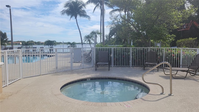 view of swimming pool with a patio and a community hot tub