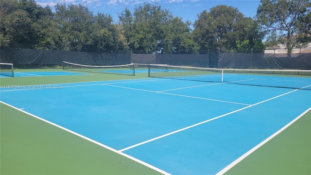 view of tennis court featuring basketball court