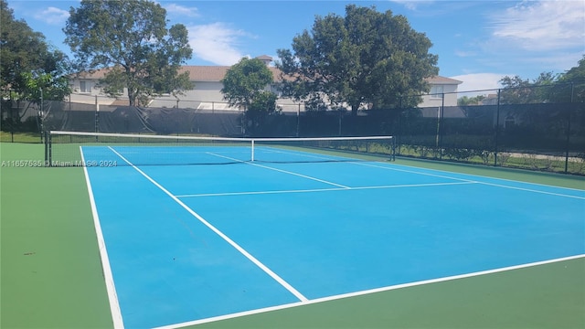 view of tennis court featuring basketball hoop