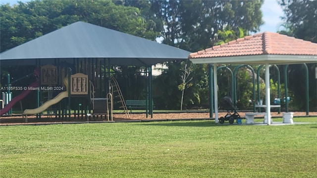 view of community with a gazebo, a lawn, and a playground